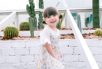 Girl Standing In Front Of Cacti