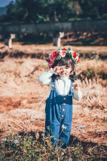 Girl Standing on Ground With Floral Headdress