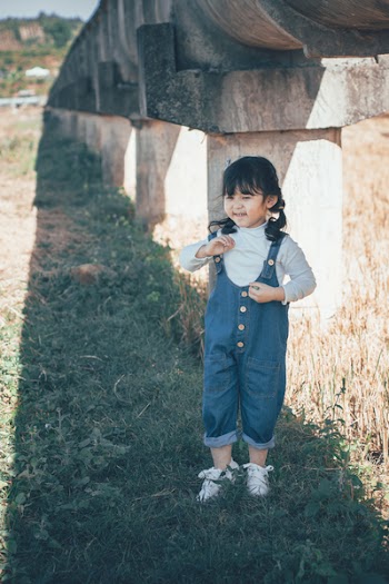 Girl Standing Under Concrete Structure
