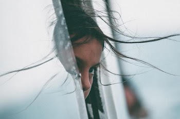 girl sticking her head in car of window