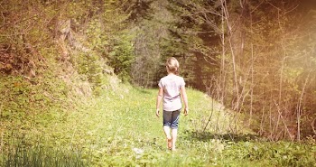 Girl Waling Across the Forest