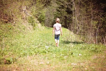 Girl Walking Across the Forest