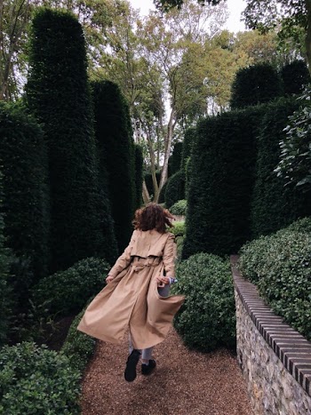 Girl Walking Between Hedge