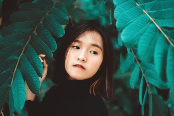 Girl Wearing Black Turtle-neck Top Surrounded by Green-leafed Tree