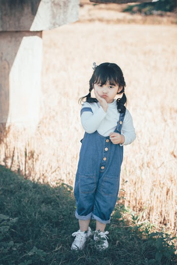 Girl Wearing Blue Denim Overalls 