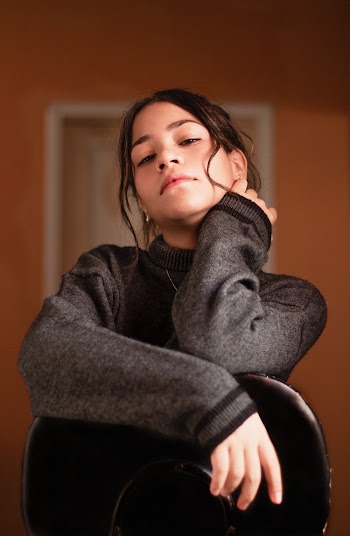 Girl Wearing Gray Turtleneck Sweater Holding Neck