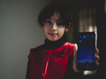 Girl Wearing Red and Black Top Holding Smartphone