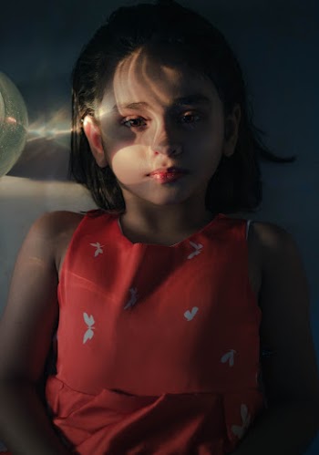 Girl Wearing Red and White Sleeveless Top