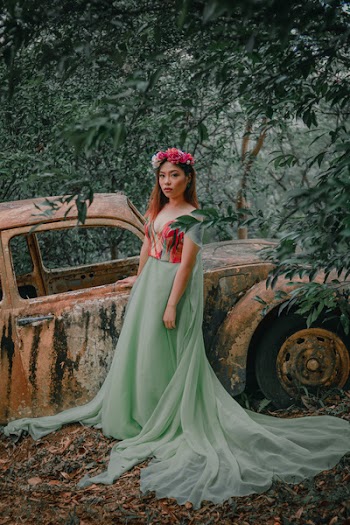 Girl Wearing Teal and Red Dress Standing Near Abandon Vehicle