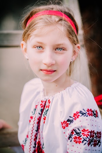 Girl Wearing White, Red, and Black Floral Blouse and Headband