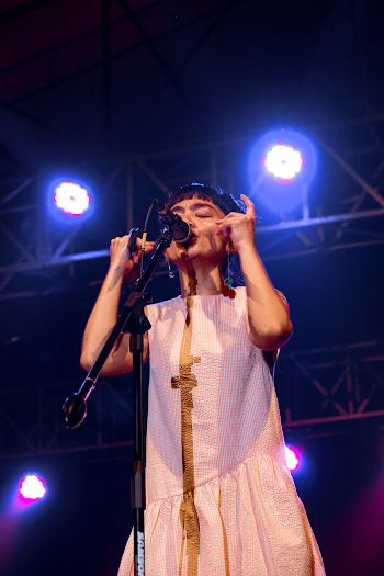 Girl Wearing White Sleeveless Dress Performing On Stage