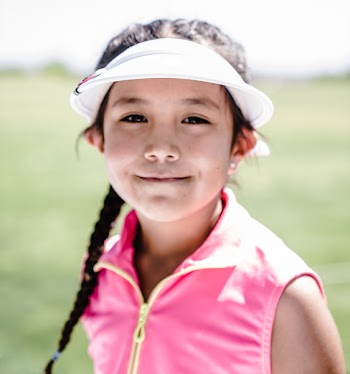 Girl Wearing White Visor Hat And Pink Zip-up Vest