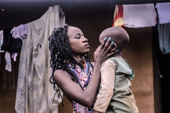 Girl With Braided Hair Standing While Carrying Boy Wearing Beige Long-sleeved Top
