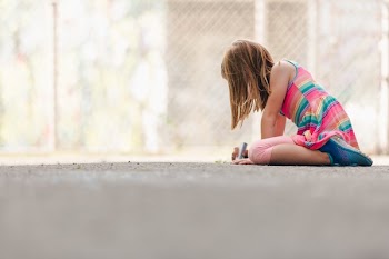 Girl With Long Hair Using Sidewalk Chalk