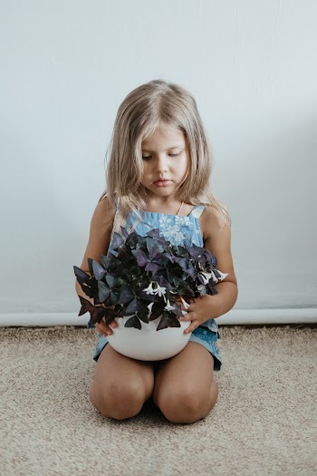 Girl With Plant on Her Knees