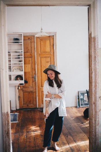 Girlfriend walking inside of our favorite Airbnb getaway apartment in Kuldiga, Latvia