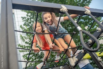 Girls having fun in jungle gym and feeling excited