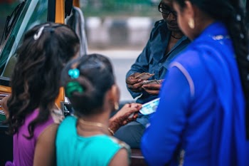 Girls Near Man Holding Money
