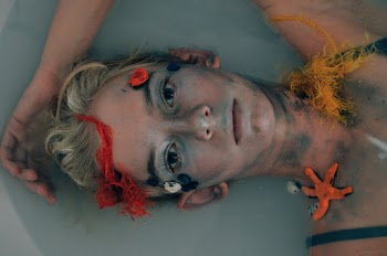 Glaring Woman Lying in Body of Water