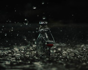 glass bottle on body of water