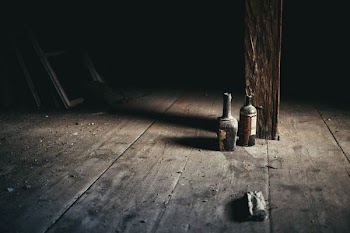 glass bottle on brown surface