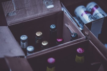 Glass Bottles on Boxes Close-up Photography