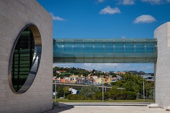 Glass Bridge Connecting Two Concrete Buildings