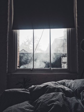glass window with blinds showing light