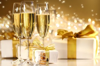 Glasses of champagne with gold ribbon gifts