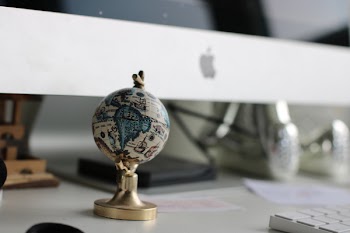 Globe On Top Of White Wooden Table