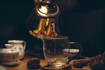 Gold Steel Kettle Beside Clear Glass Pitcher