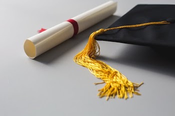 Gold Tassle Graduation Cap And Diploma