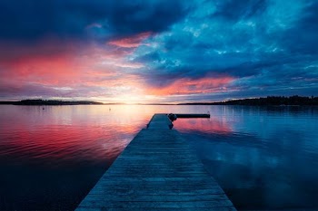 golden hour photography of docking pier on body of water