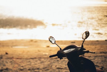 Golden Hour Photography of Motorcycle Near Body of Water
