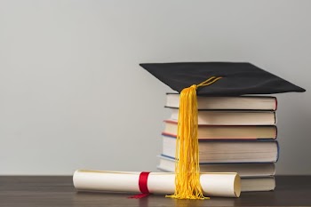 Grad Cap Diploma And Stacked Books