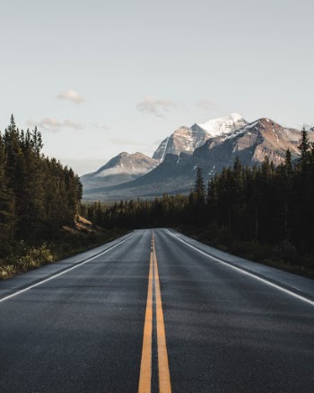 Grand vistas and pastel skies accompany the drive through the Canadian Rockies.