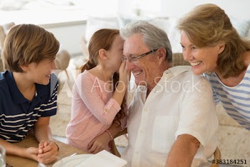 Granddaughter sharing secret with grandfather