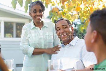 Grandparents and grandson talking on autumn patio