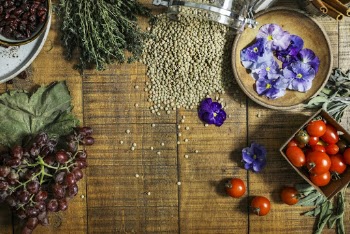 Grapes, Tomatoes, and Purple Flower on Brown Wooden Table