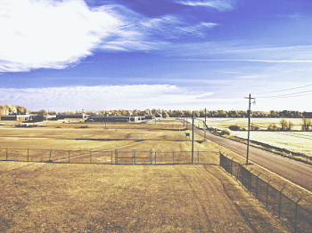 Grass Field Surrounded by Fences