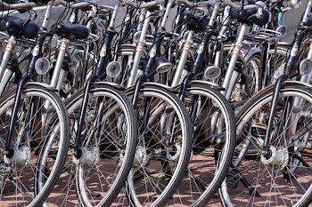 Gray and Black Bicycles Parked Near Gray Wall