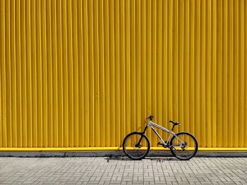 gray and black bike leaning on wall