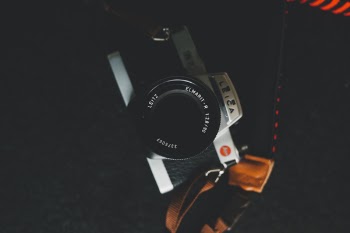 Gray and Black Leica Dslr Camera on Black Surface
