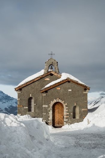 gray and brown cathedral surrounded by snow pile