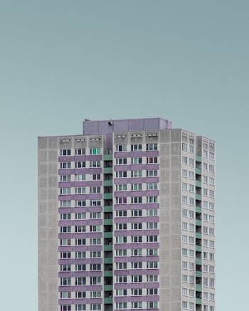 gray and purple high rise building under white clouds
