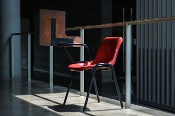 gray and red chair near the glass wall