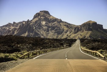 Gray Asphalt Road Towards Brown Mountain