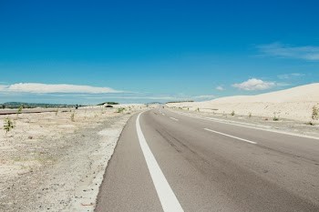 Gray Asphalt Road Under White and Blue Skies