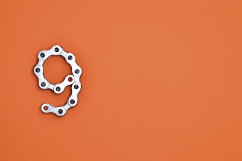Gray Bicycle Chain on Orange Surface