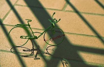 gray bicycle miniature on concrete pavement